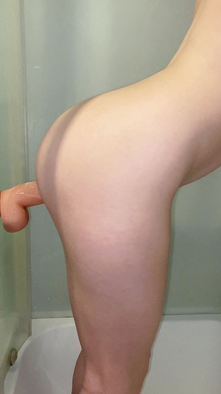 Long big dildo goes deep into tight pussy in the shower