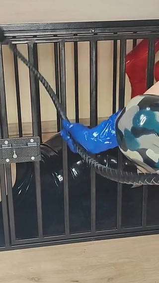 Latex Officer Fucks His Latex Prisoner with a Strap-on