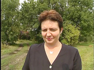 Lovely mature lady blows a guy's cock outdoors near the car