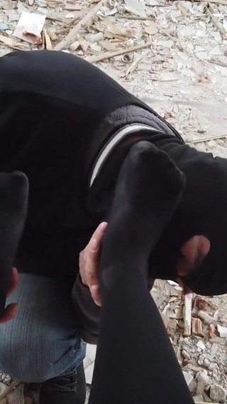 He worships her black stocking feet