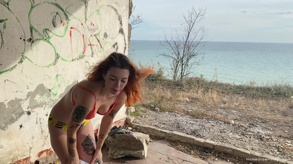 Kate gets a mouthful of cum outdoors by the sea