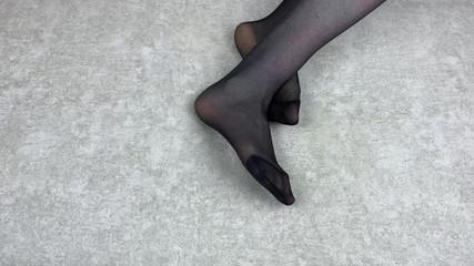 Mistress Caresses Her Feet in Black Nylon Pantyhose