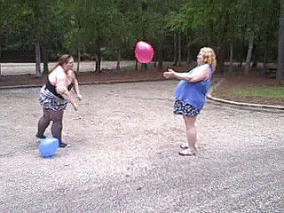 BBW gals play volley ball with balloons